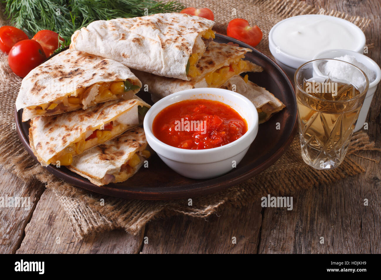 Sliced quesadilla with chicken and vegetables on a plate close-up. horizontal Stock Photo