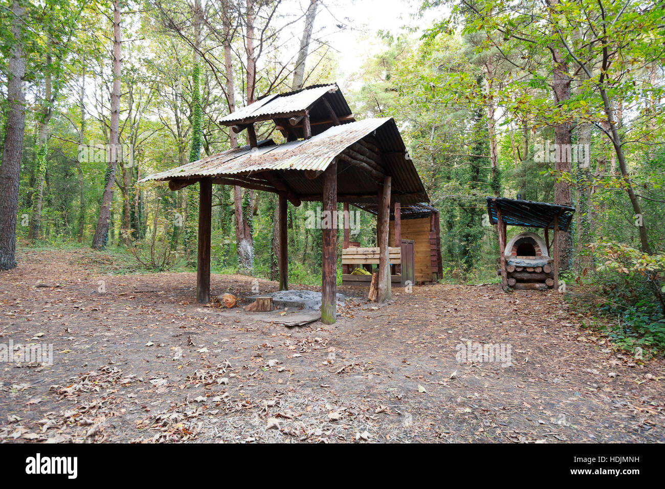 hand built oven and shelter in woodland camp Stock Photo