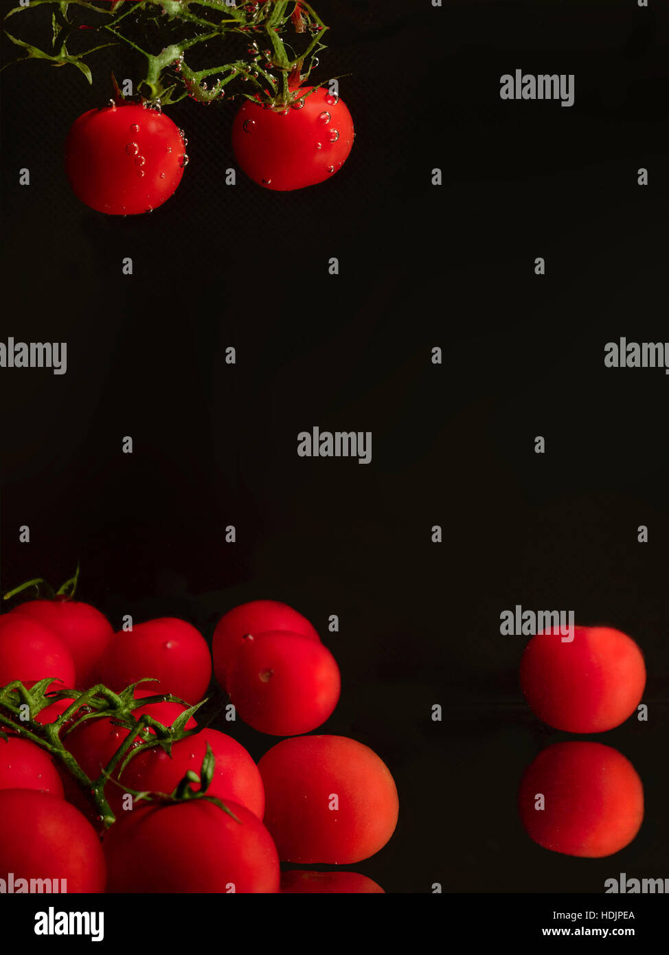 Cherry tomatoes in dark background Stock Photo - Alamy
