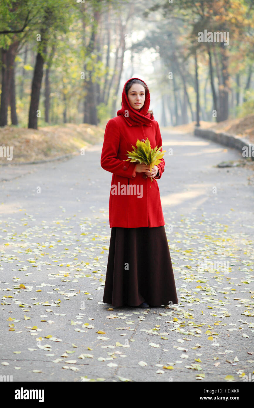 Beautiful young girl walking in autumn park Stock Photo - Alamy