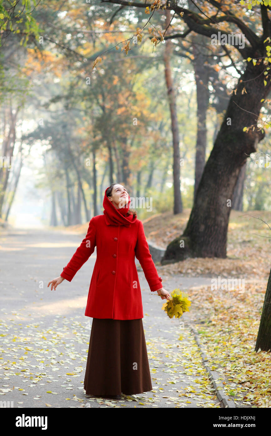 Beautiful young girl walking in autumn park Stock Photo - Alamy