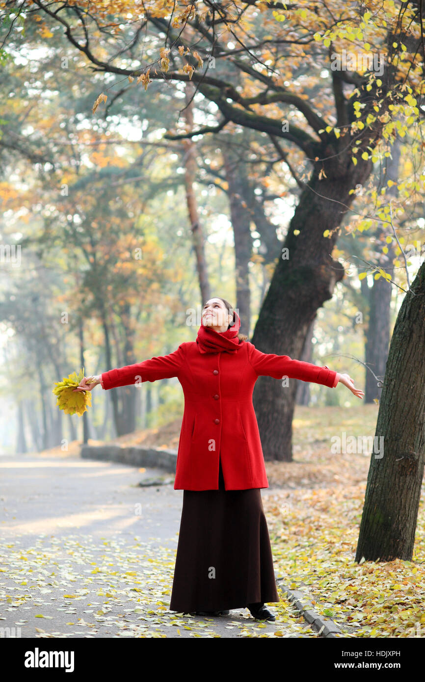 Beautiful young girl walking in autumn park Stock Photo - Alamy