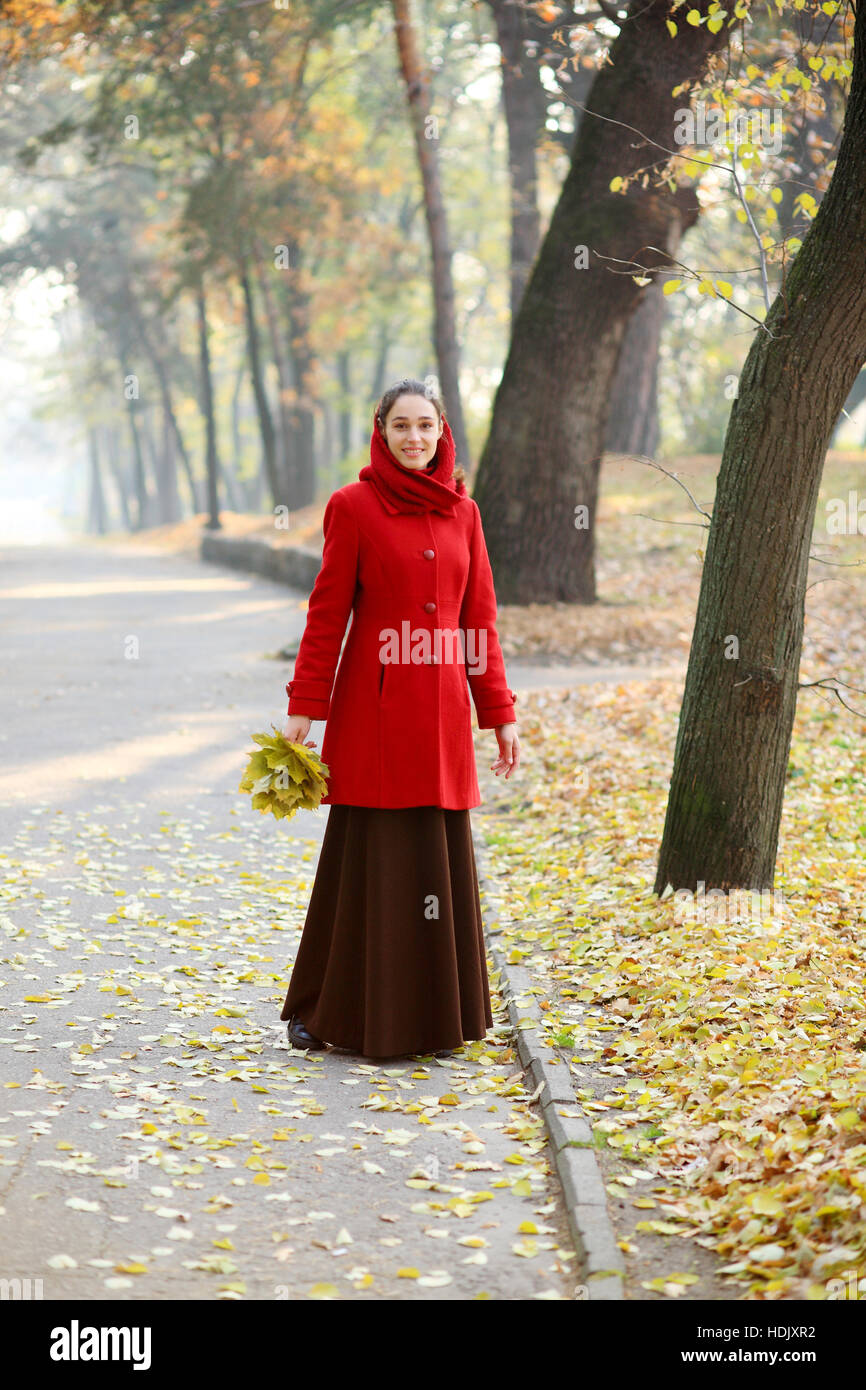 Beautiful young girl walking in autumn park Stock Photo - Alamy