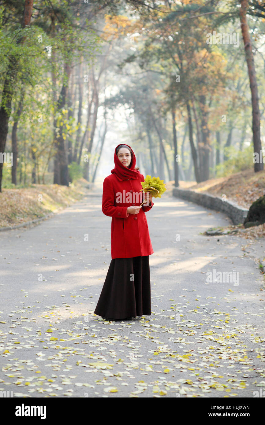 Beautiful young girl walking in autumn park Stock Photo - Alamy
