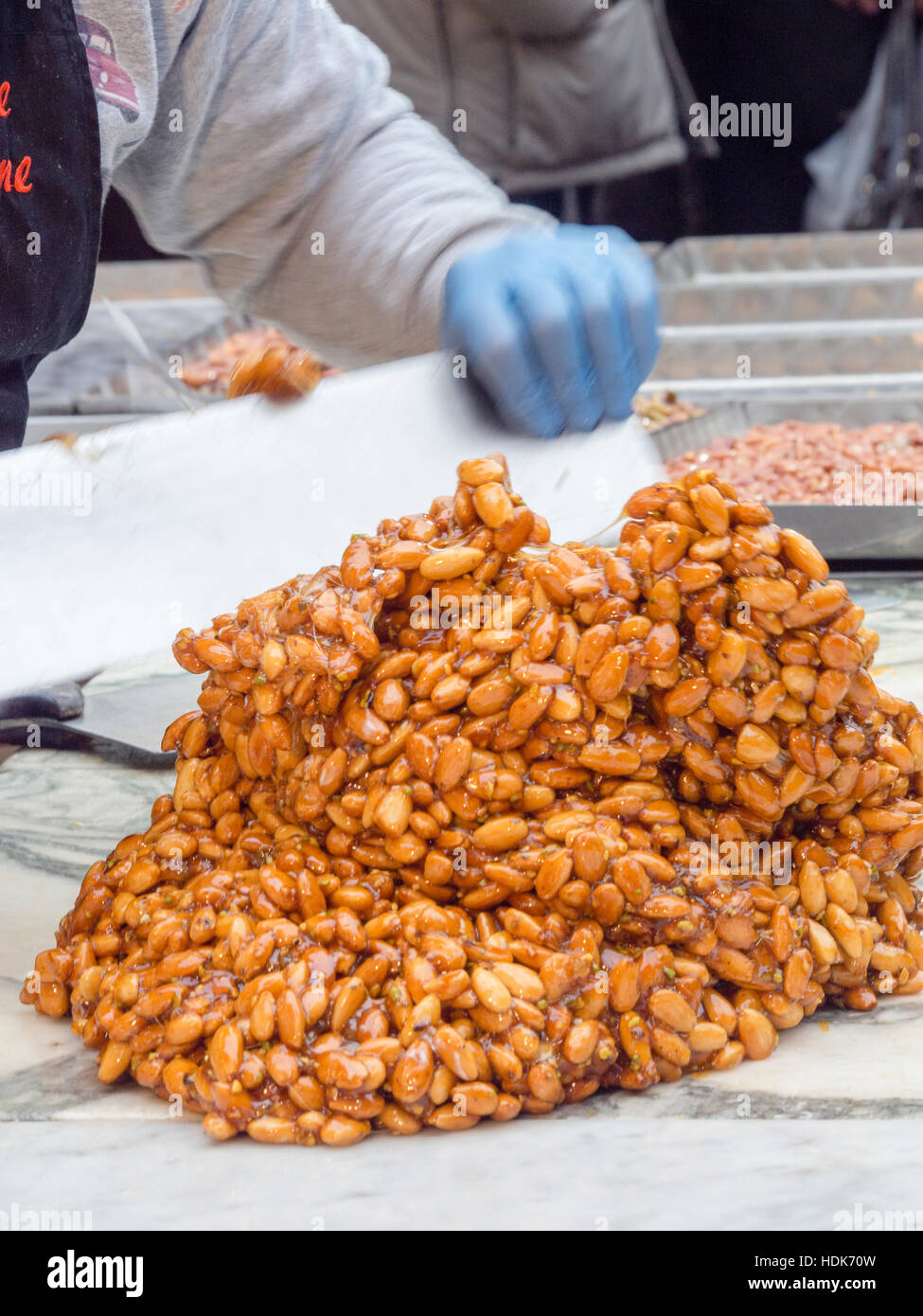 Making almond brittle , street live demo, Festa del Torrone, Cremona, november 2016 Stock Photo