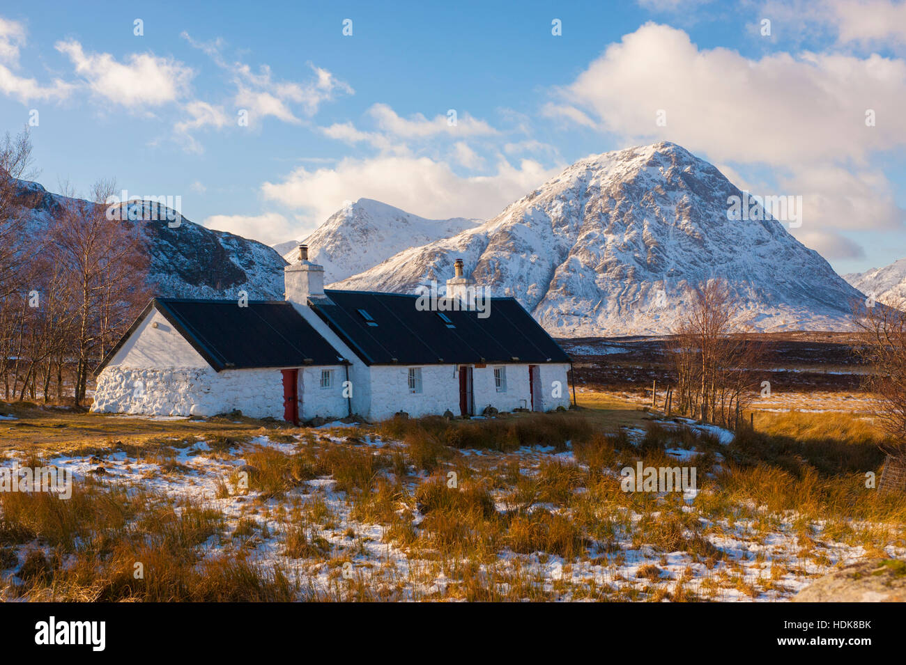 Black Rock Cottage near the entrance to Glen Coe in winter with Stob Dearg behind Stock Photo