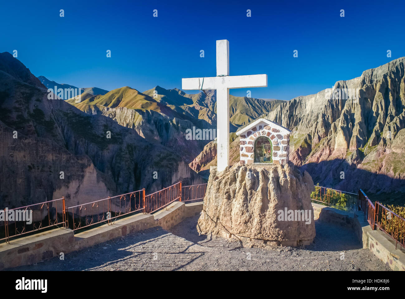 Photo of large white cross with large mountain range in background in Argentina. Stock Photo