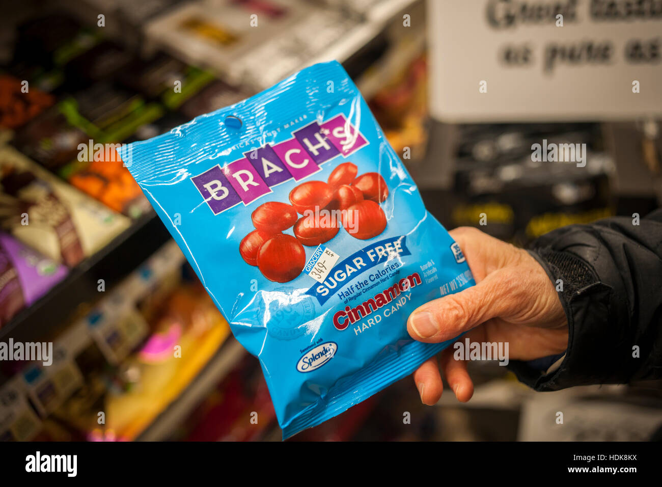 A shopper chooses a bag of Ferrrara Candy Co.'s Brach's hard candy in a  supermarket in New York on Friday, December 9, 2016. Media reports that the  former CEO of Hershey's David