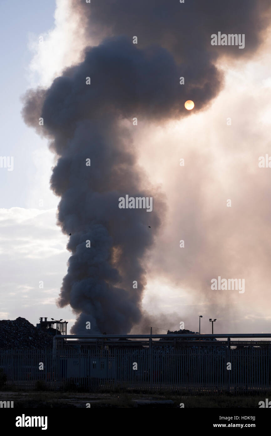 Fire, smoke, and sun Stock Photo
