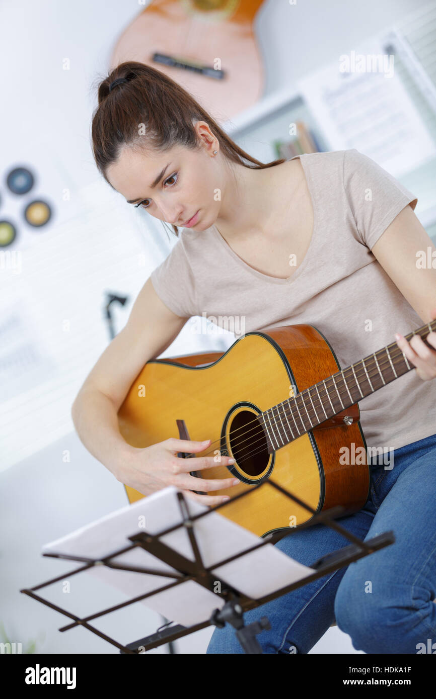 young woman playing on acoustic guitar Stock Photo - Alamy