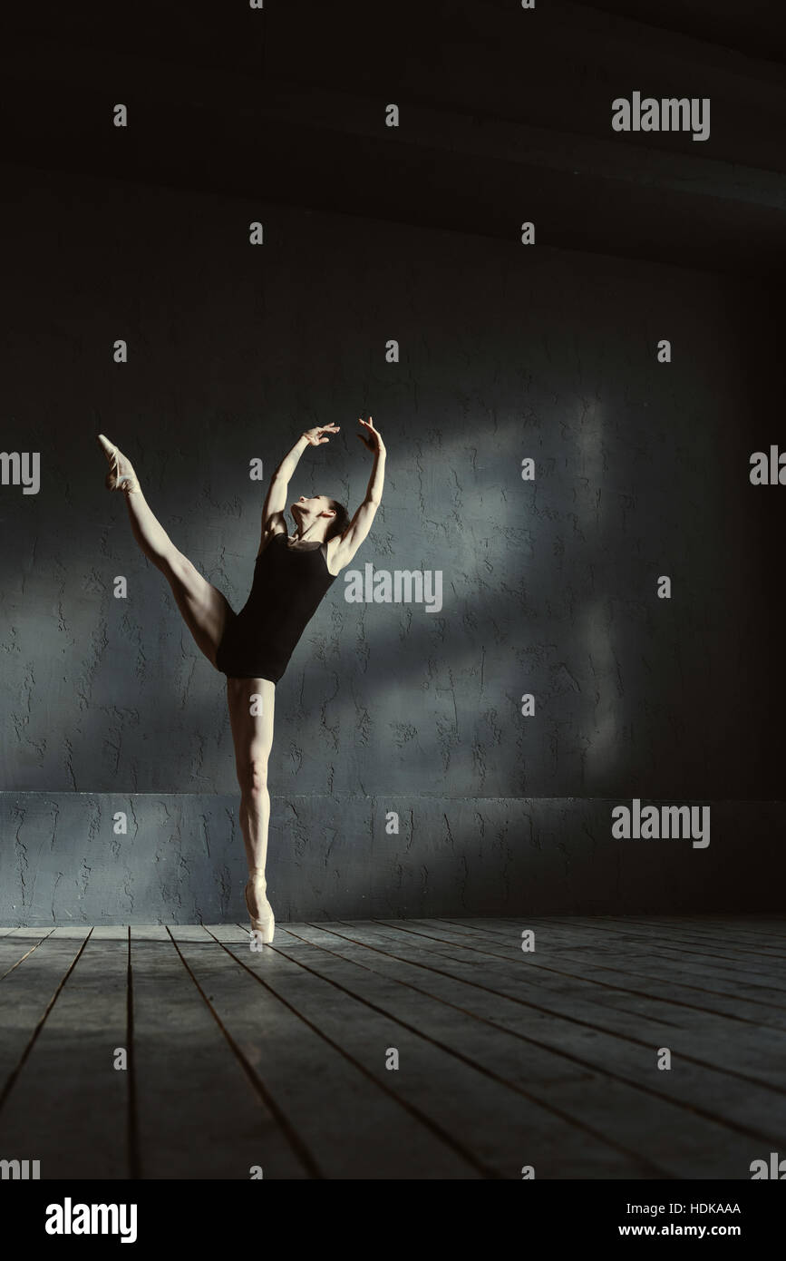 Flexible dancer standing on the tiptoe and performing the split Stock Photo