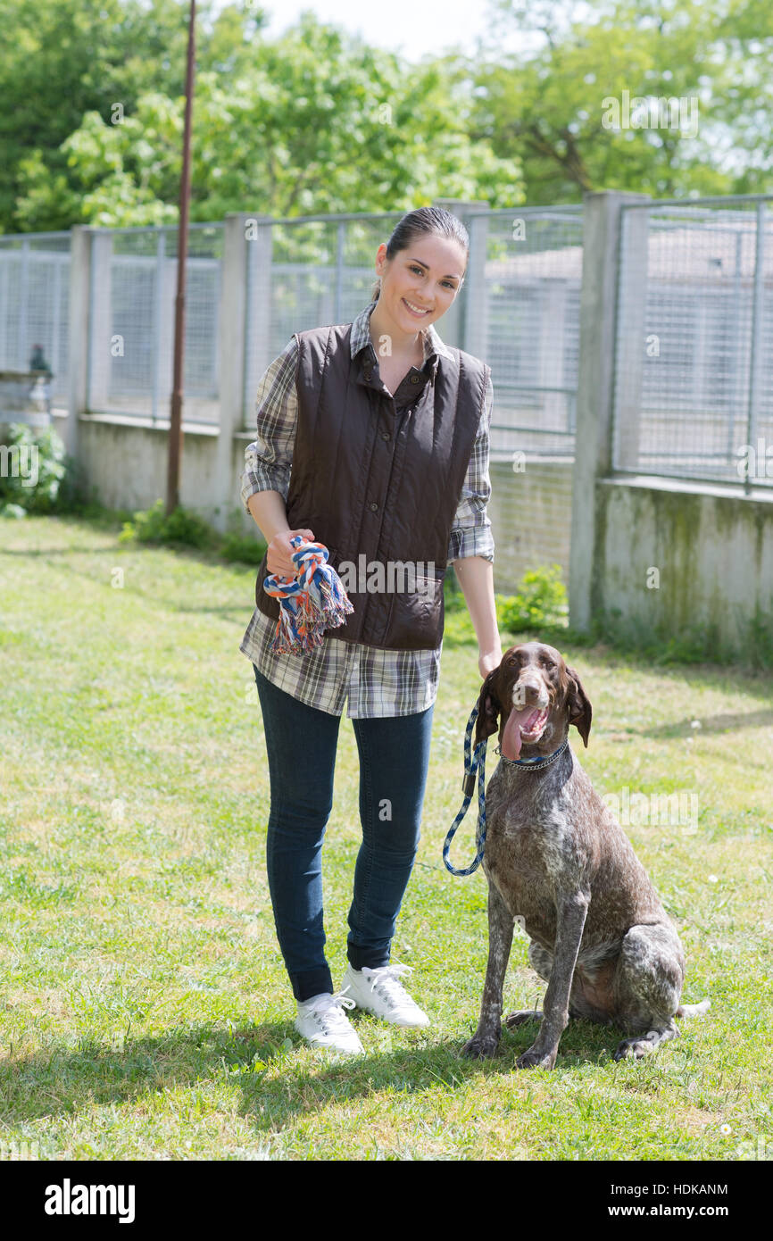 dedicated girl training dog in kennel Stock Photo
