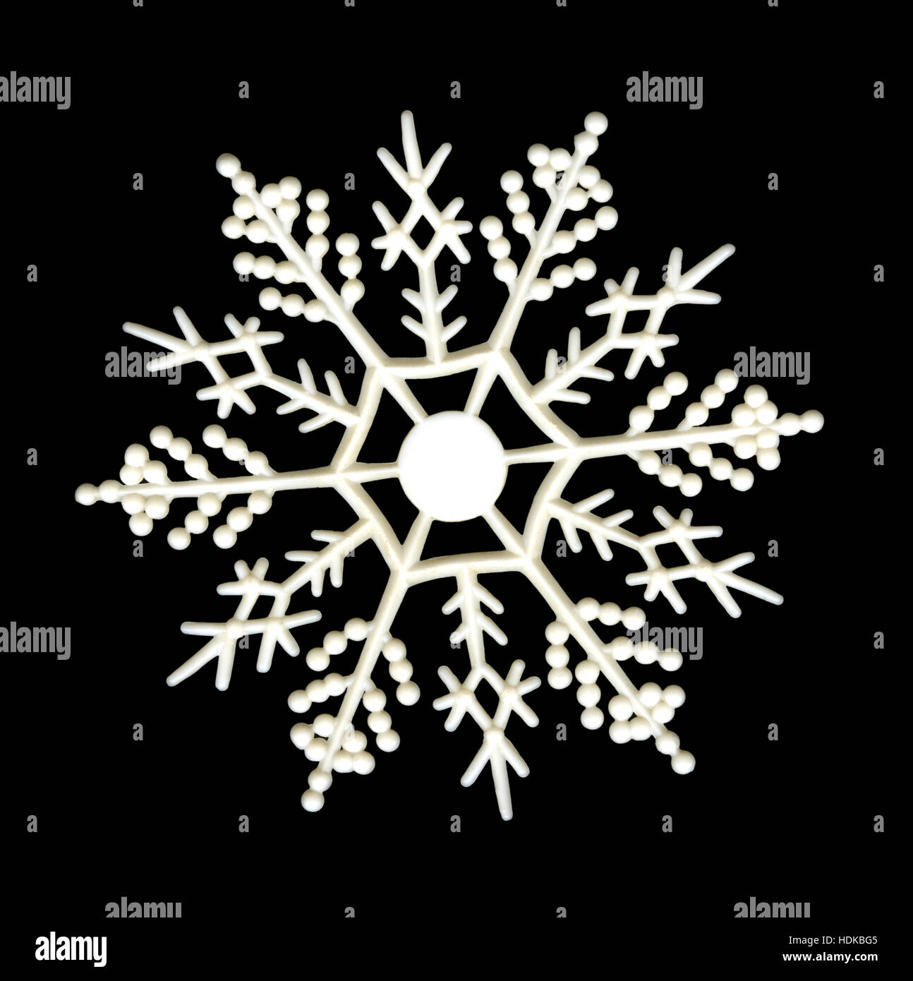 White plastic snowflake ornament on black background Stock Photo