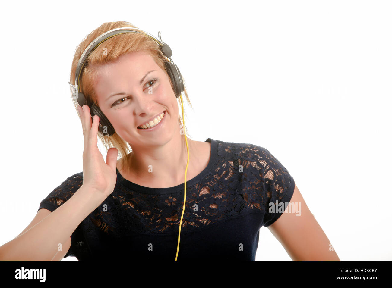 Young woman listening to music through headphones Stock Photo - Alamy