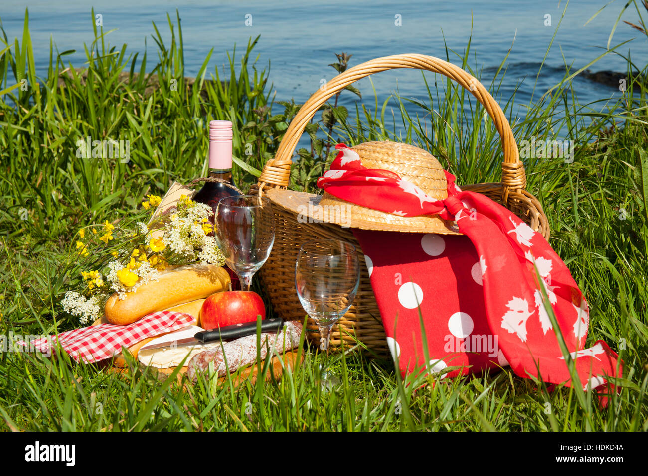 Picnic basket in the grass with tasty food and wine Stock Photo Alamy