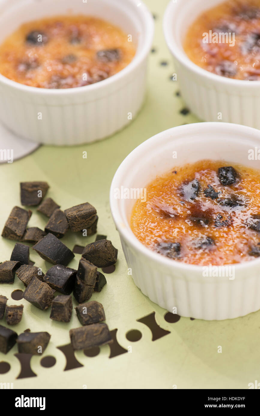 Creme brulee. Sweet french dessert served with liquorice in bowl Stock