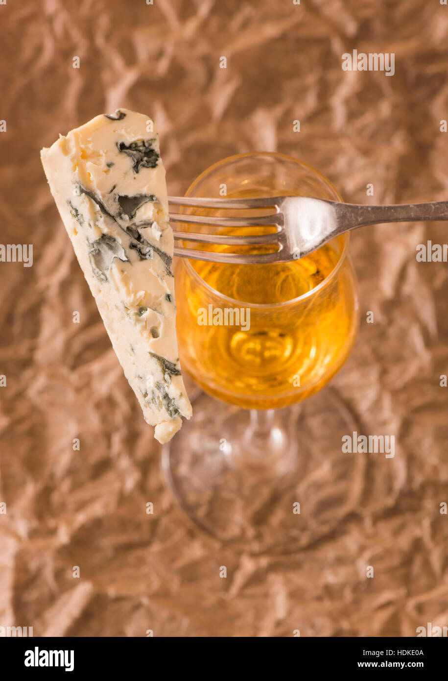 Blue cheese and white dessert wine in glass. Rustic french food as snack or appetizer. Stock Photo