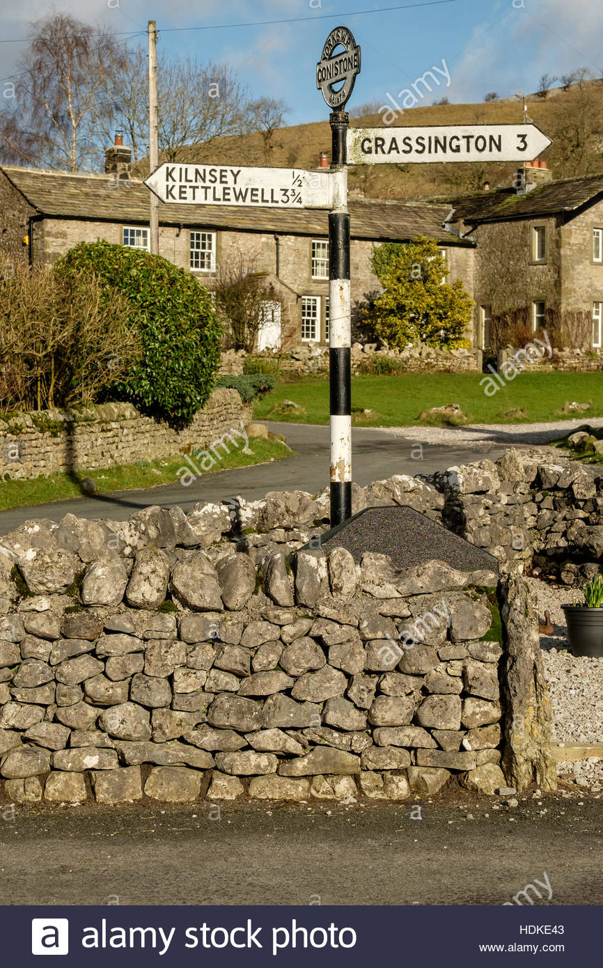 The centre of Conistone village in the Yorkshire Dales, North Yorkshire, England with an old metal signpost giving directions. Stock Photo