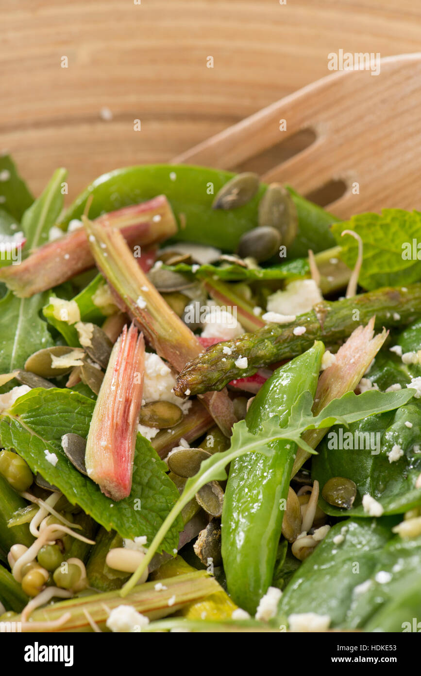 Salad with rhubarb, asparagus and feta cheese in close up. Stock Photo