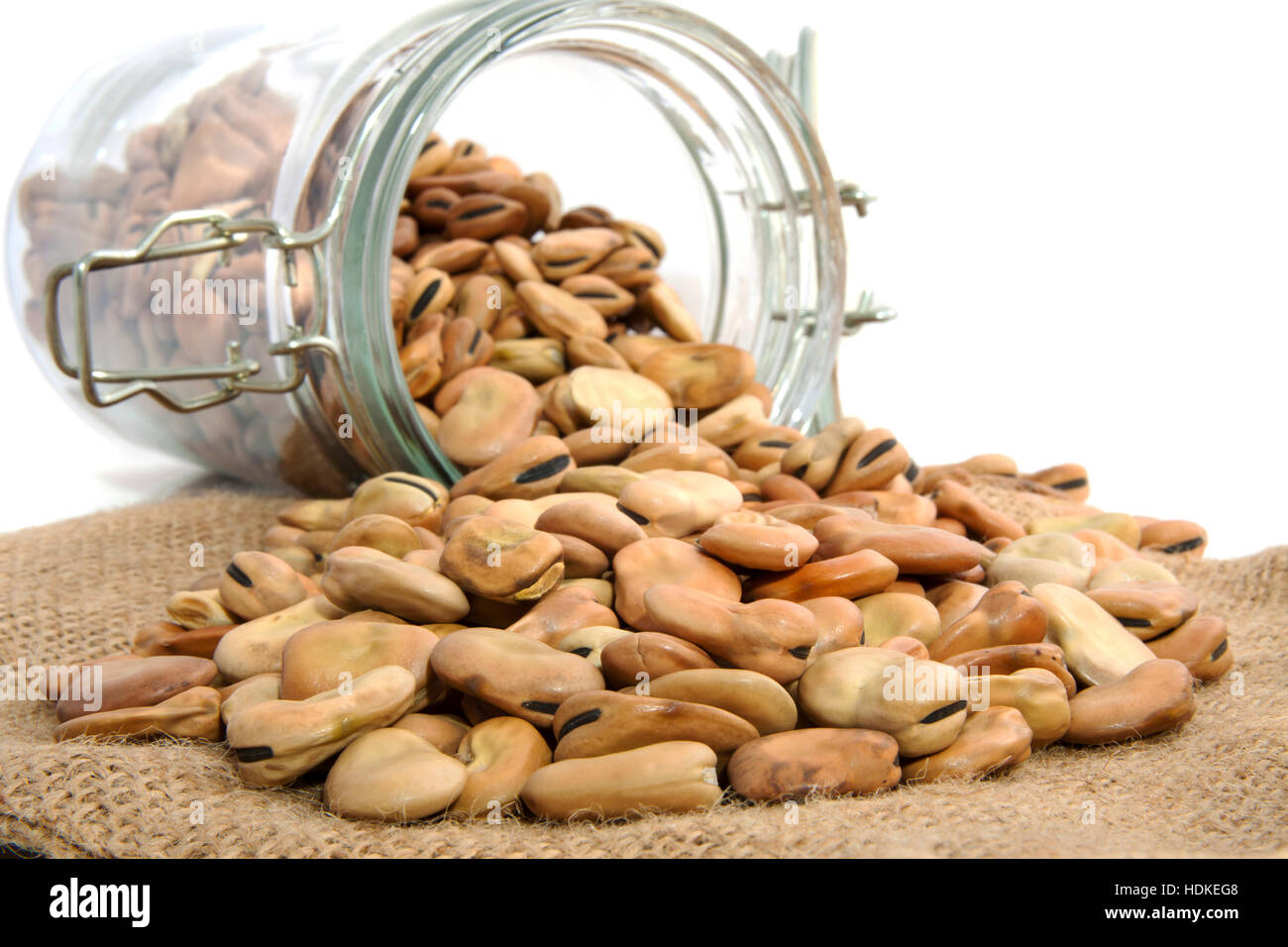 Beans in glass jar and on jute cloth isolated over white Stock Photo