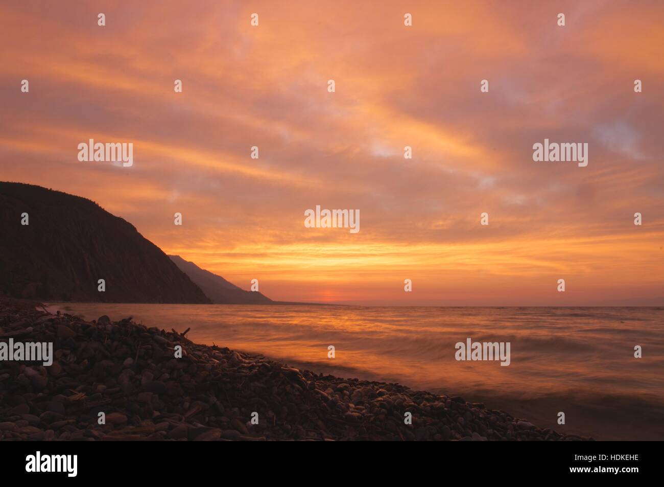 the sunrise at Lake Baikal in summer with orange background Stock Photo
