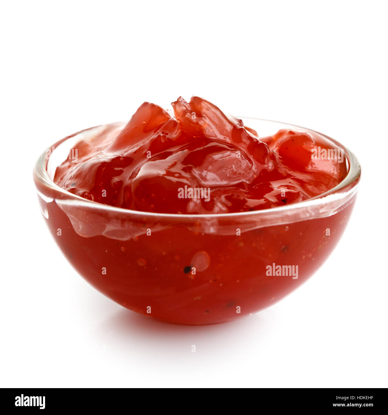 Red onion chutney in glass bowl isolated on white. Stock Photo