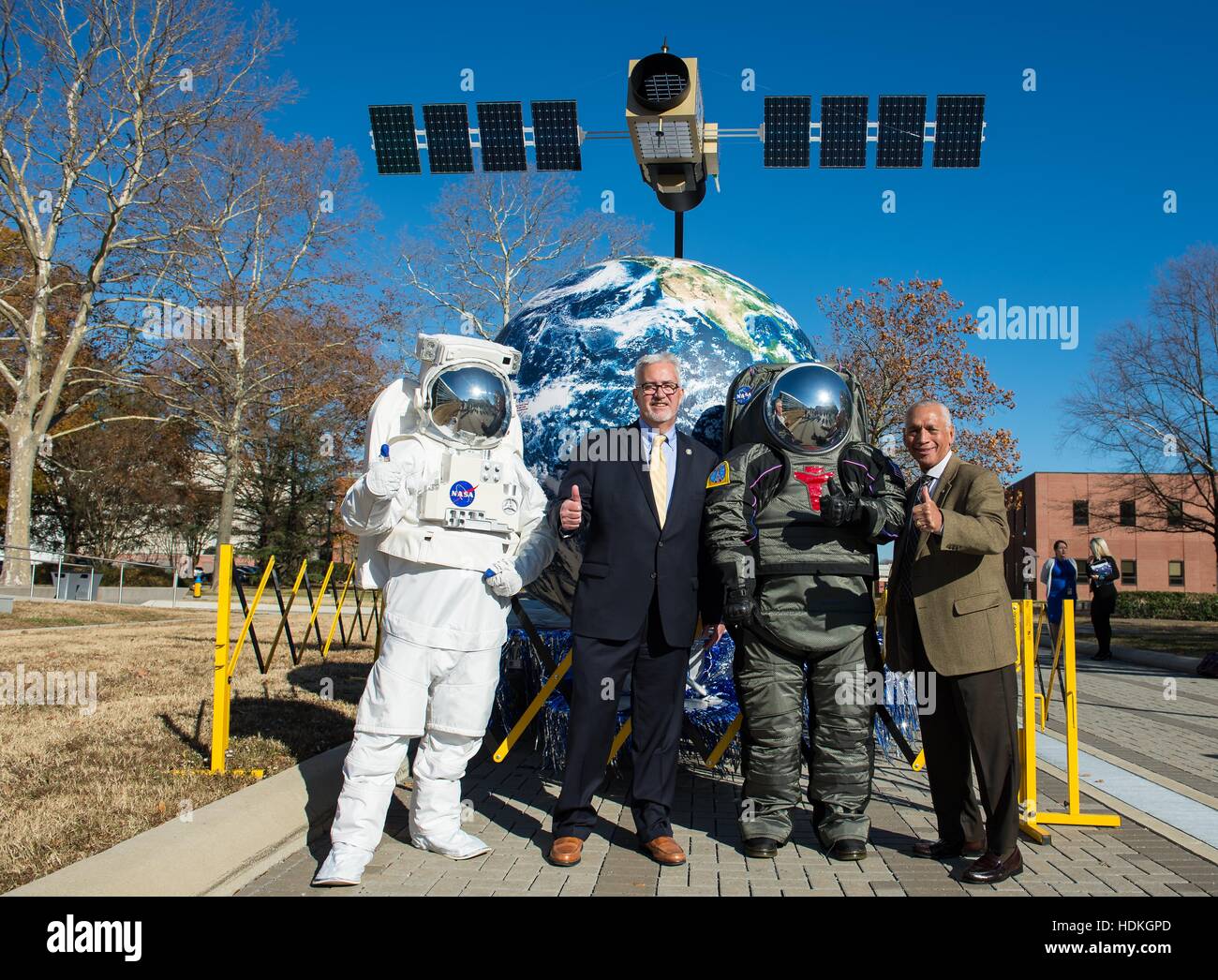Langley Research Center Director Dr. David Bowles (left) and NASA Administrator Charles Bolden pose with astronaut mascots in spacesuits during the Centennial Float at the Langley Research Center December 1, 2016 in Hampton, Virginia. Stock Photo