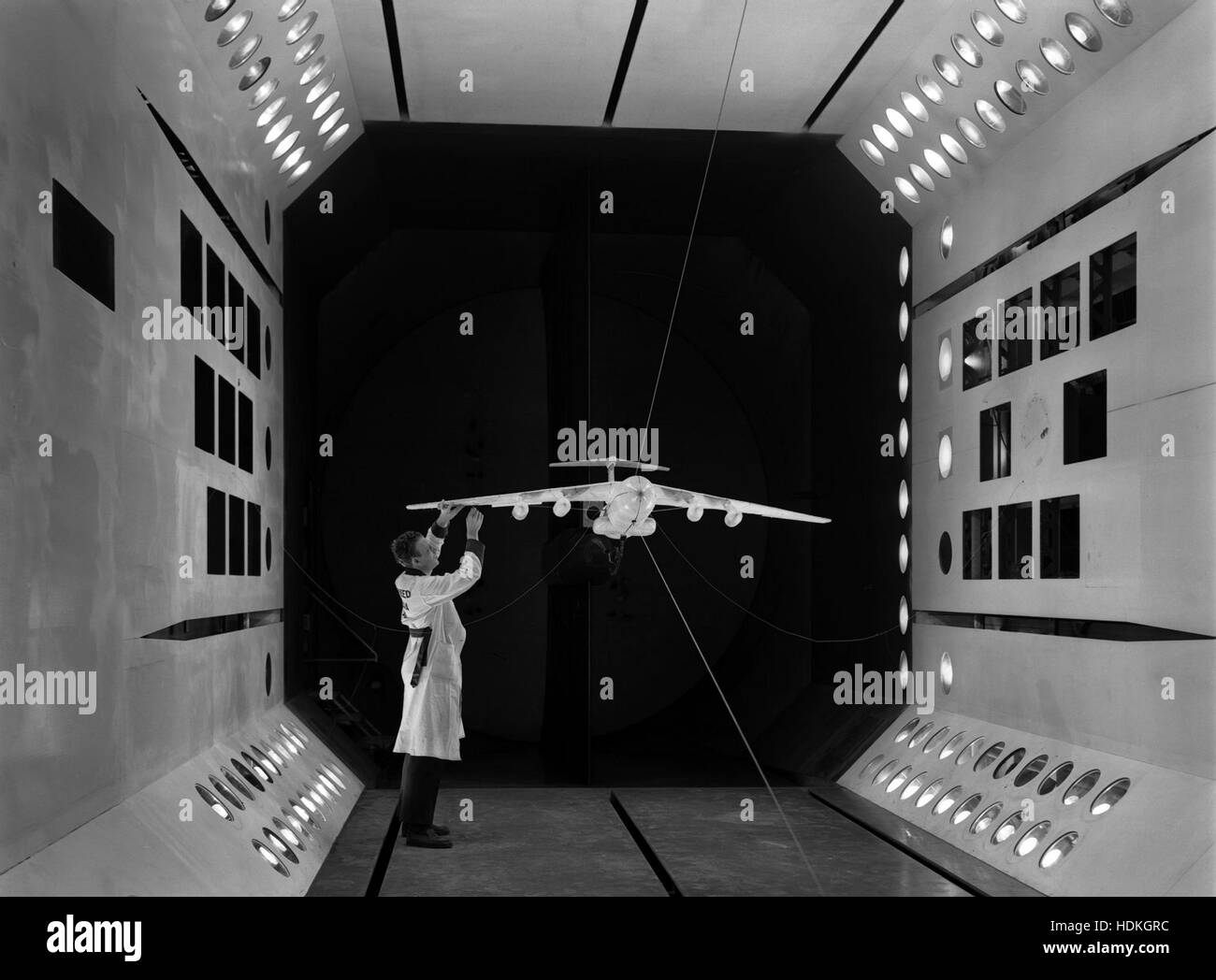 A National Advisory Committee on Aeronautics (NACA) scientist performs dynamic tests on a model support system of the Lockheed C-141 strategic airlifter aircraft at the Langley Research Center Transonic Dynamics Tunnel November 16, 1962 in Hampton, Virginia. Stock Photo