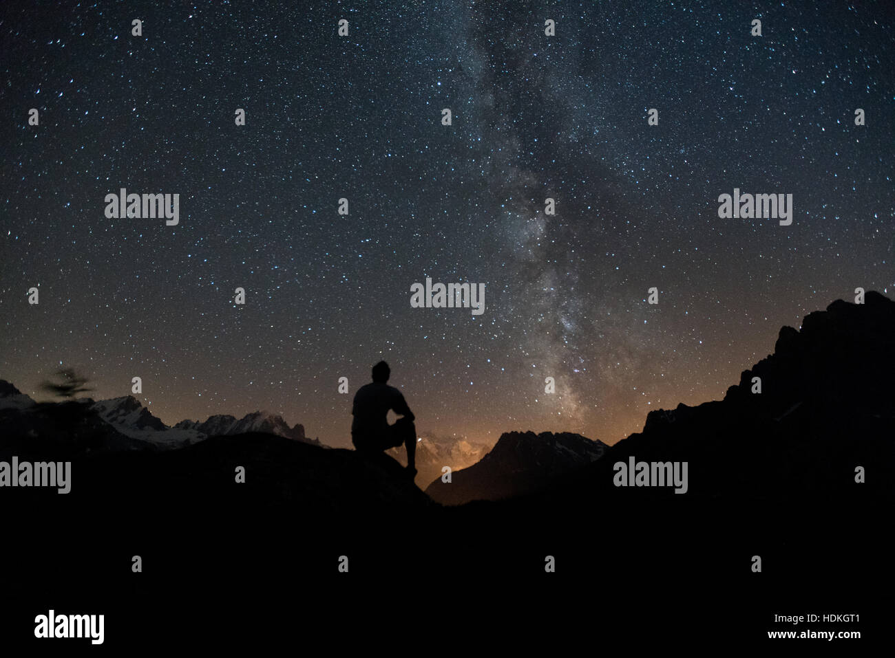 Milky Way. Night sky with stars and silhouette of a man Stock Photo - Alamy