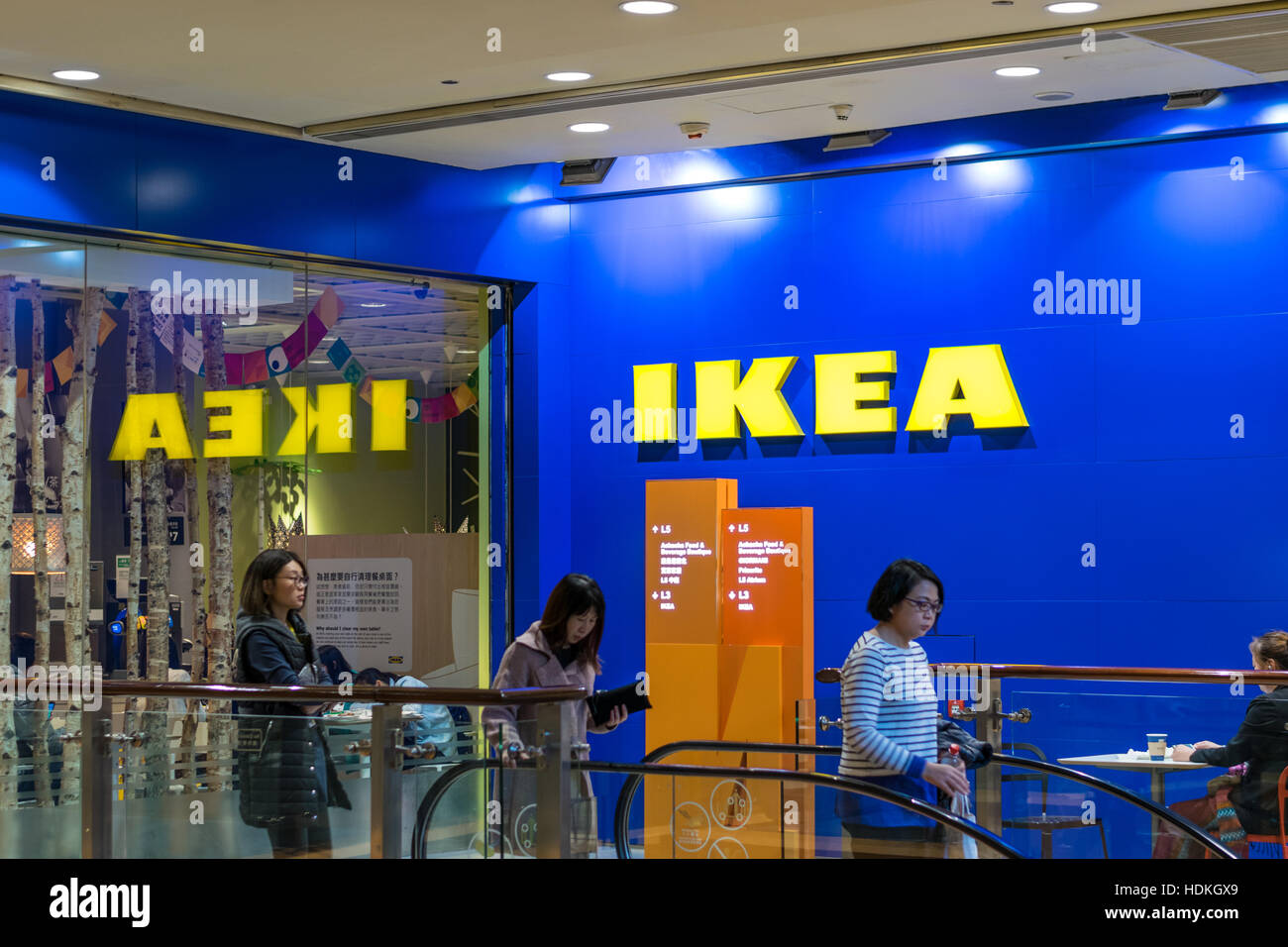 Shoppers walking past Ikea logo in Hong Kong Stock Photo Alamy