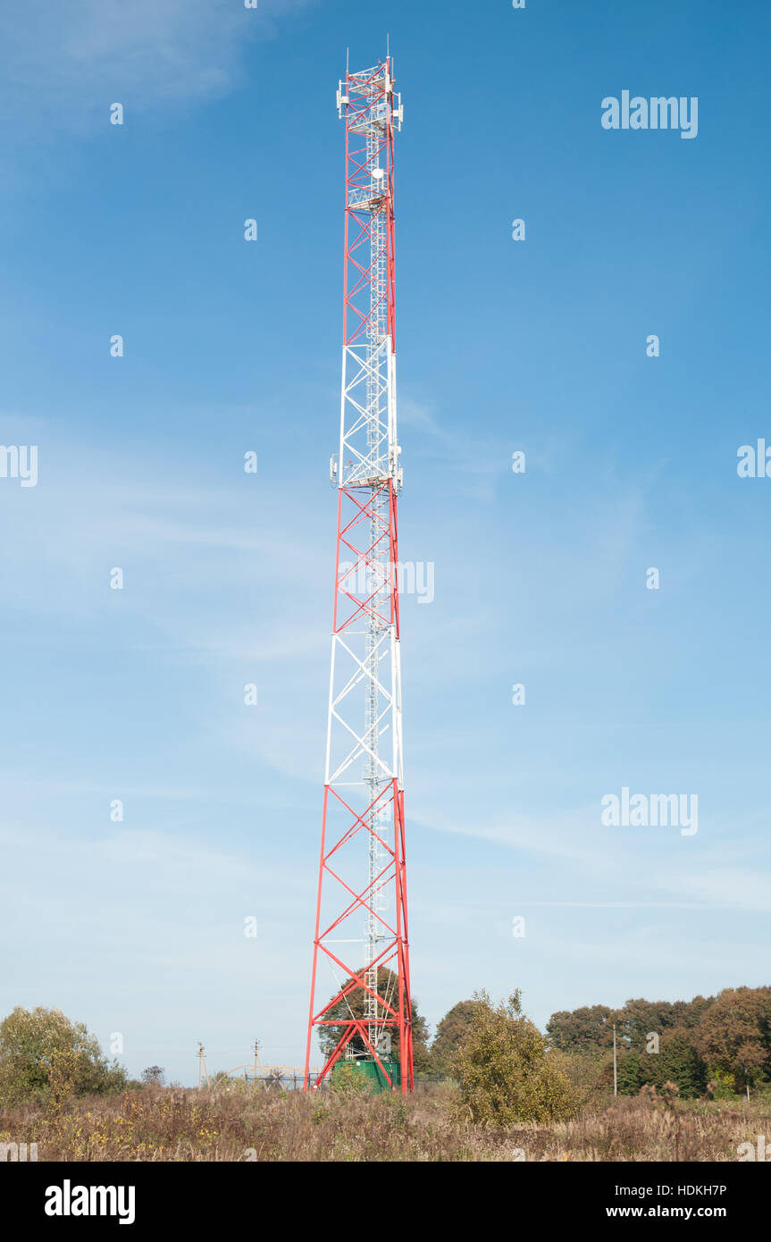 Telecommunications tower on blue sky background. Stock Photo