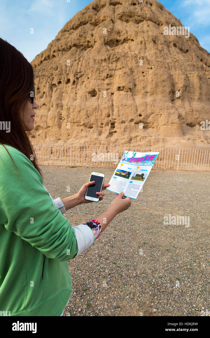 Chinese tourist reading a map at Western Xia Mausoleum, Yinchuan, Ningxia, China Stock Photo