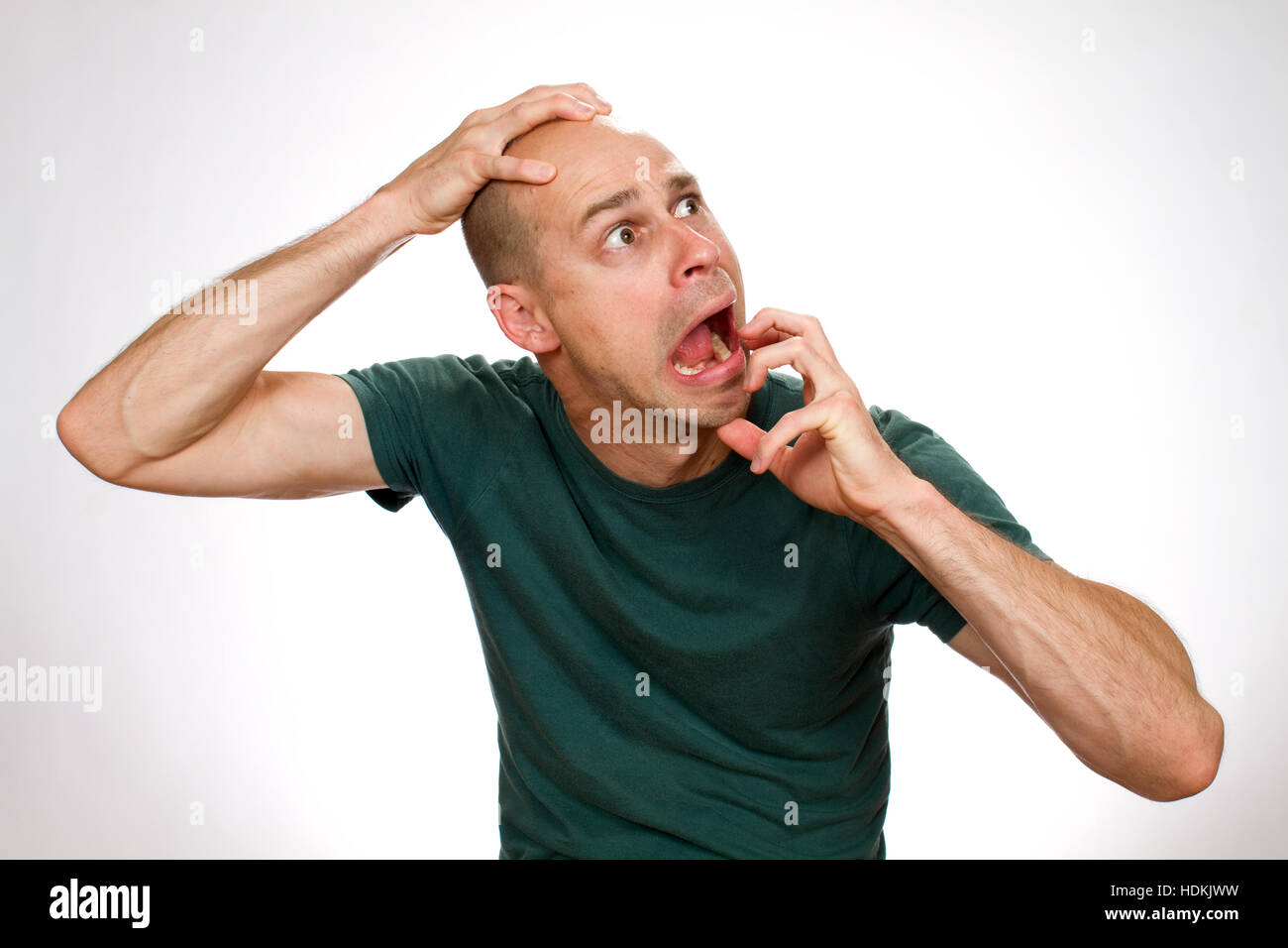 Comical man expresses fear in a funny pose. Stock Photo