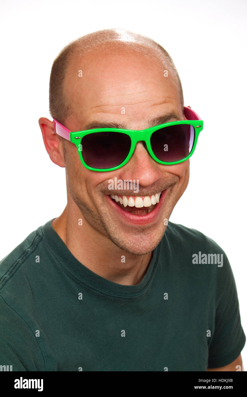 Man with a silly grin on his face wears colorful sunglasses. Stock Photo