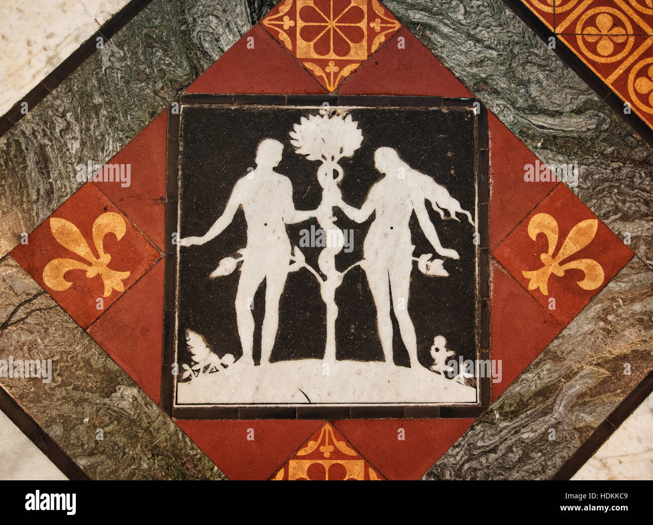 Adam and eve the serpent in black and white inlay floor tiles with tile and marble  at Gloucester Cathedral Gloucestershire UK Stock Photo