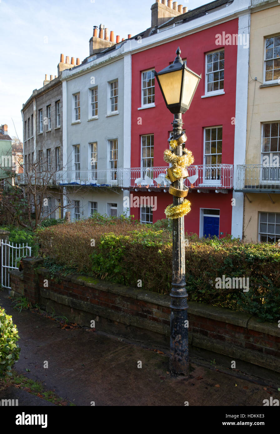 Lamp post decorated for Christmas with five gold rings at The Polygon a small crescent of Georgian houses in Hotwells Bristol Stock Photo