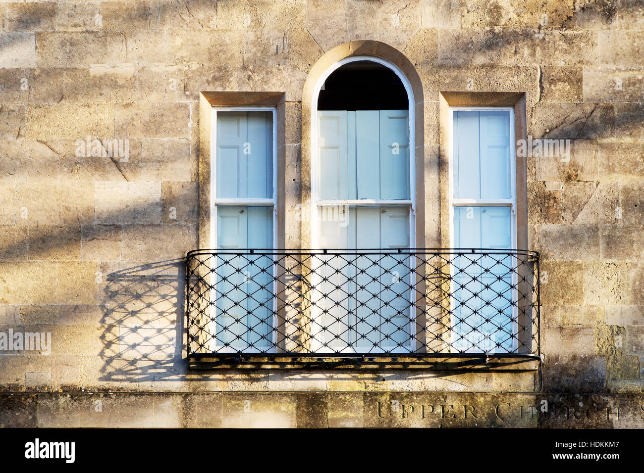 Elegant window with shutters stone lullions and ironwork balcony on a building in Bath Somerset UK Stock Photo