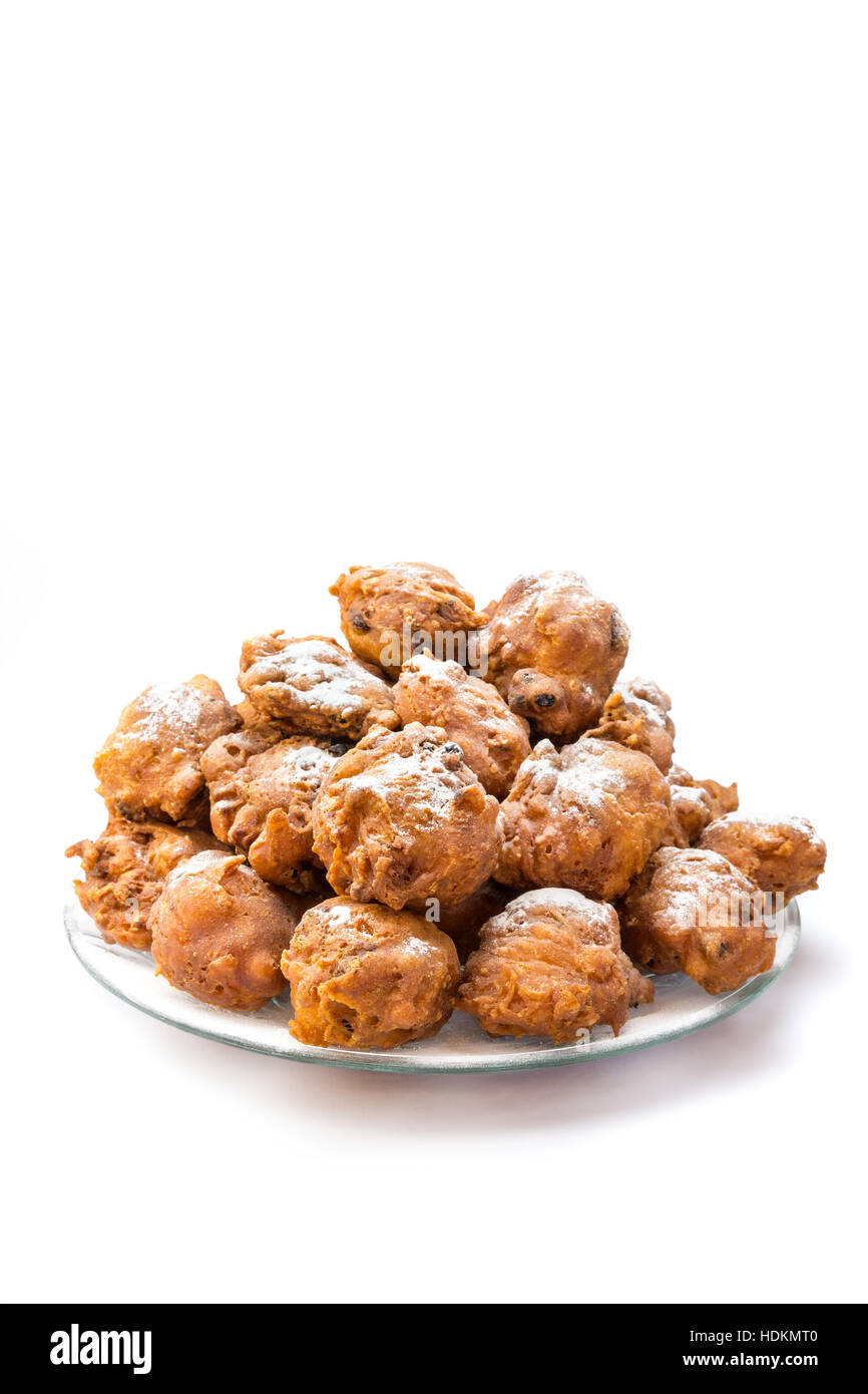 Heap of sugared oliebollen or fried fritters on glass dish isolated on white background Stock Photo