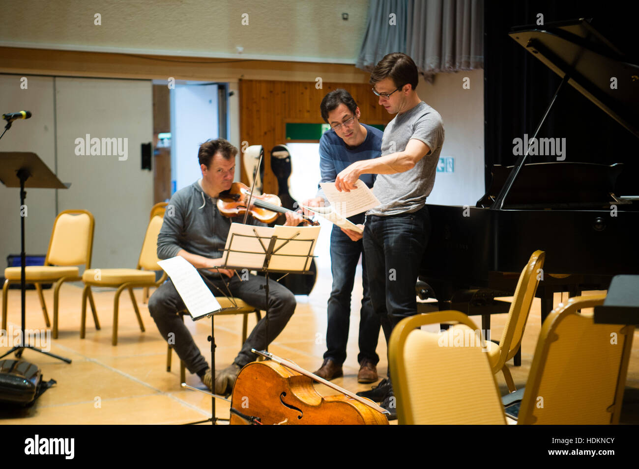 Tom Poster (piano), Guy Johnston (cello) and Magnus Johnston (violin) rehearsing for their evening concert at MusicFest Aberystwyth , Wales UKL - July 2016 Stock Photo