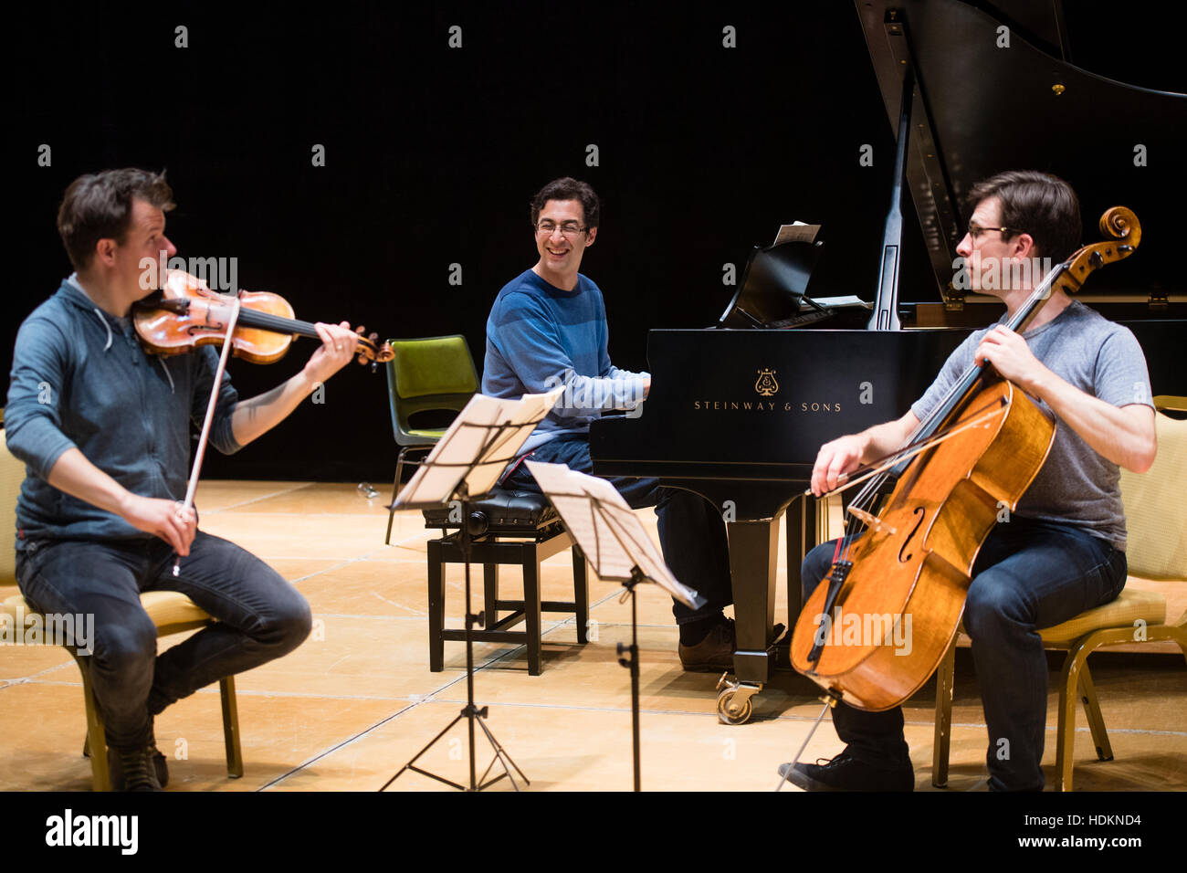 Tom Poster (piano), Guy Johnston (cello) and Magnus Johnston (violin) rehearsing for their evening concert at MusicFest Aberystwyth , Wales UKL - July 2016 Stock Photo