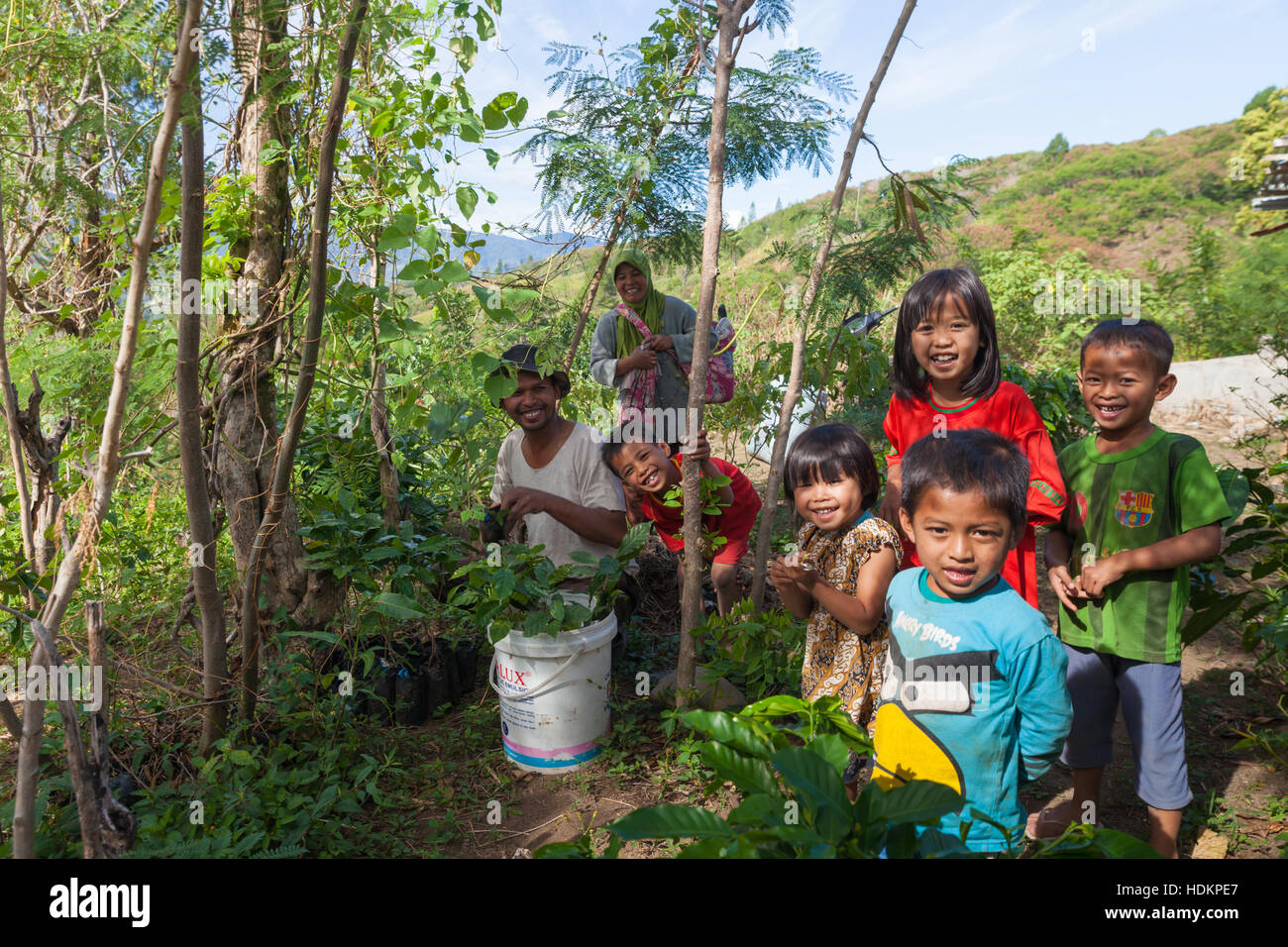 Muslim family preparing to plant coffee seedlings in mountain Stock Photo