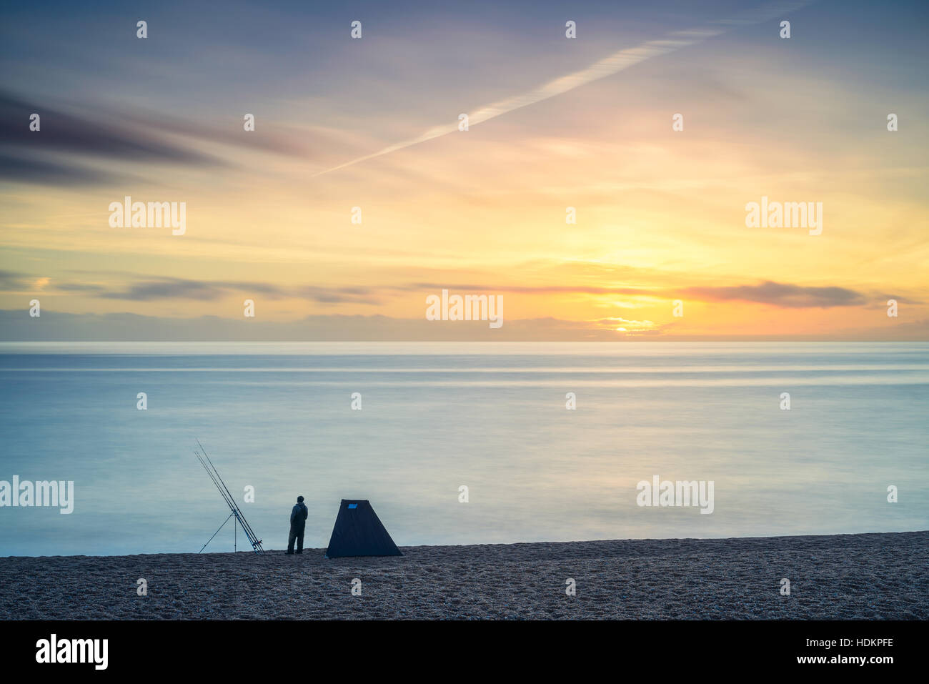 Fisherman on Chesil Beach at sunset, Dorset, England, UK Stock Photo Alamy