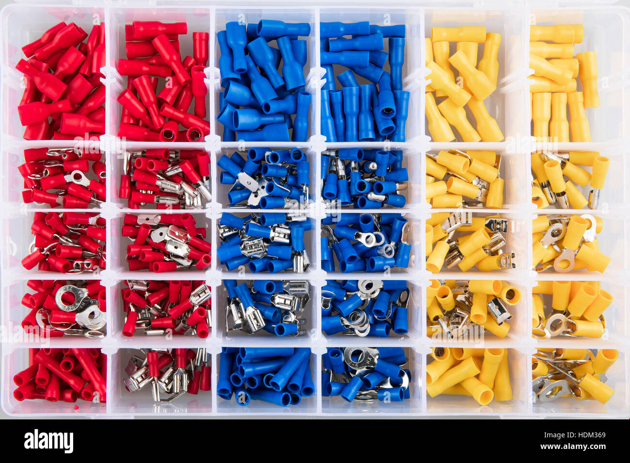 Yellow, blue and red electric terminal connectors organized in plastic