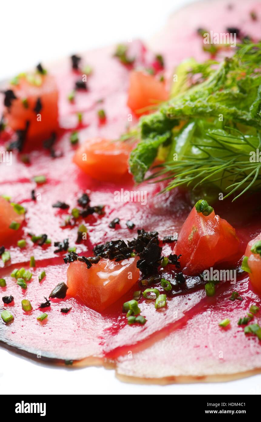 forefront of carpaccio of tuna with diced tomatoes Stock Photo Alamy