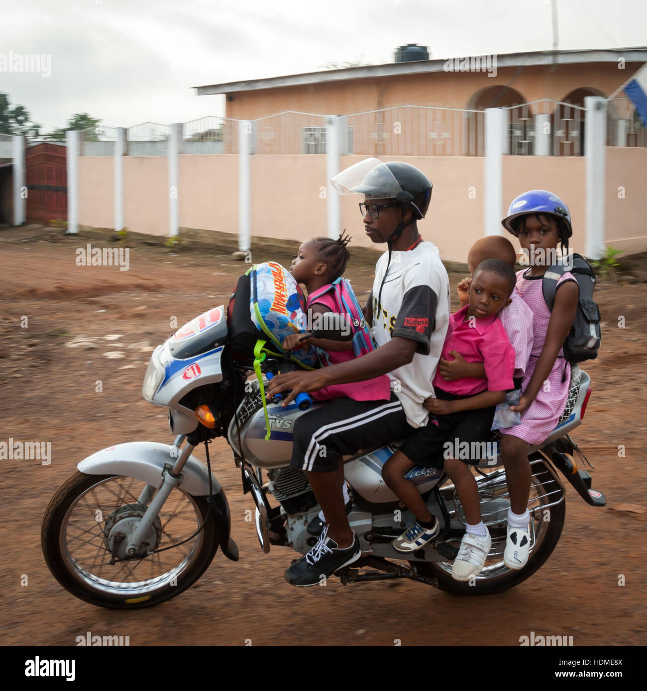 Okada (motorcycletaxi in Sierra Leone) carrying four passengers. In Europe you take a car for this Stock Photo