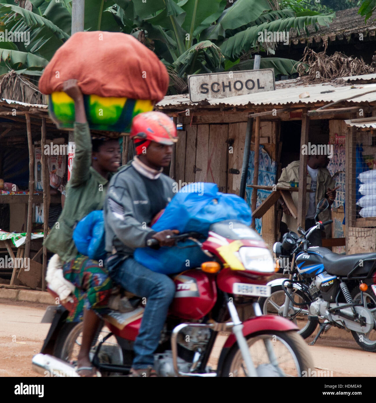 Okada in front of a school in Sierra Leone Stock Photo