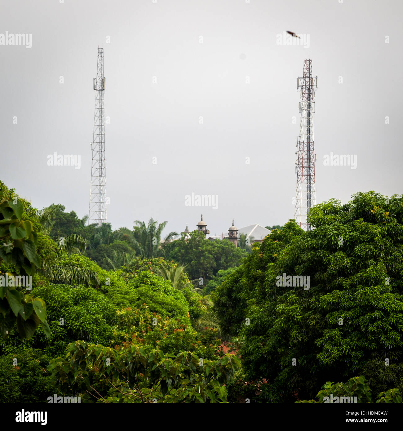 Cell phone towers and mosque in Kenema, Sierra Leone Stock Photo