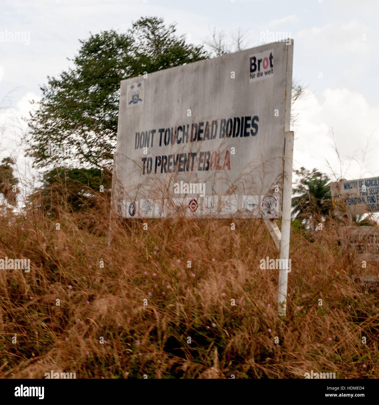 A billboard beside the road in the Gola rainforest area, Sierra Leone, warns against touching dead bodies to prevent Ebola infection. Stock Photo