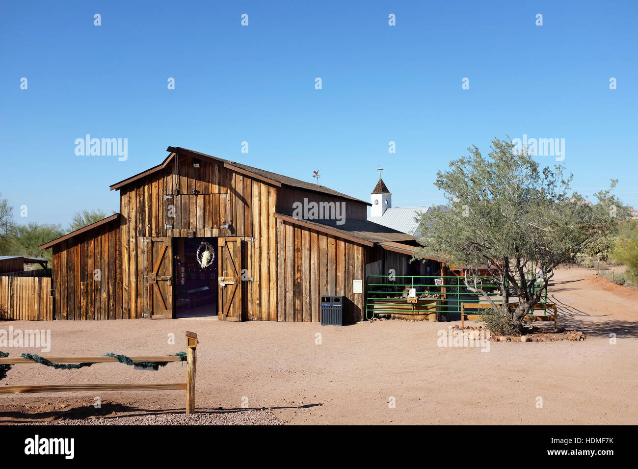 Apacheland Barn with the  Elvis Memorial Chapel in the background at the Superstition Mountain Museum in Apache Junction, Ariizona. Stock Photo