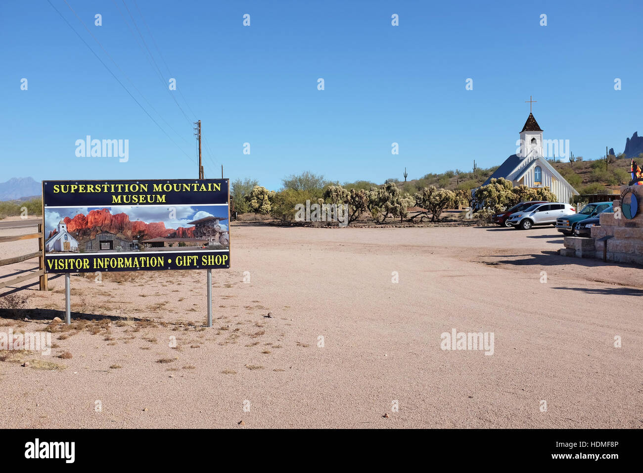 Parking Lot and Sign at the Superstition Mountain Museum on Route 88 in Apache Junction, Arizona. The Elvis Memorial Chapel is in the background. Stock Photo
